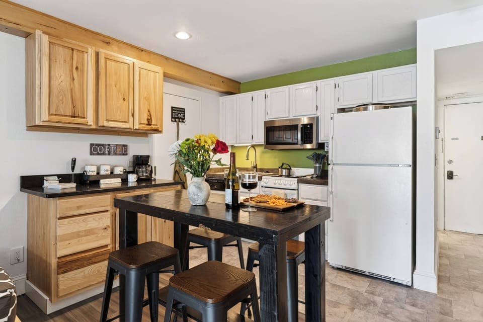Dining island set for a meal, showcasing the warm wood cabinetry.