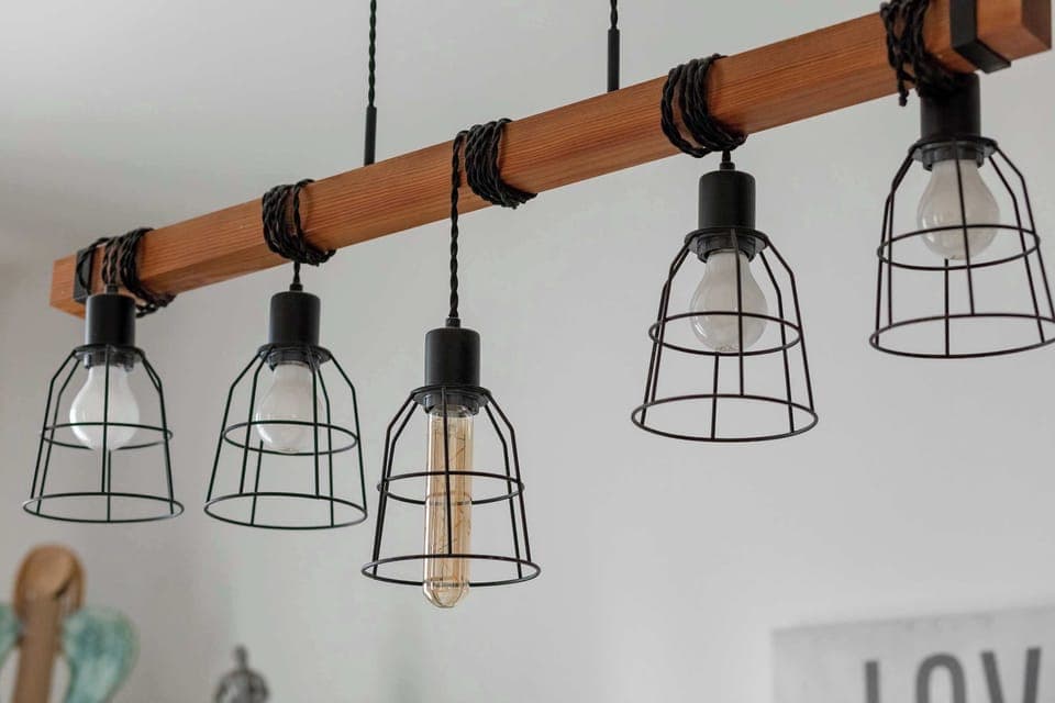 Industrial-style lighting fixture above the dining area.