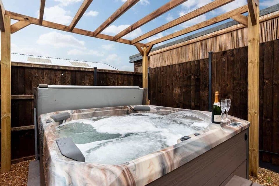 Hot Tub Retreat: Unwind and indulge in luxury with bubbly and serene surroundings!
