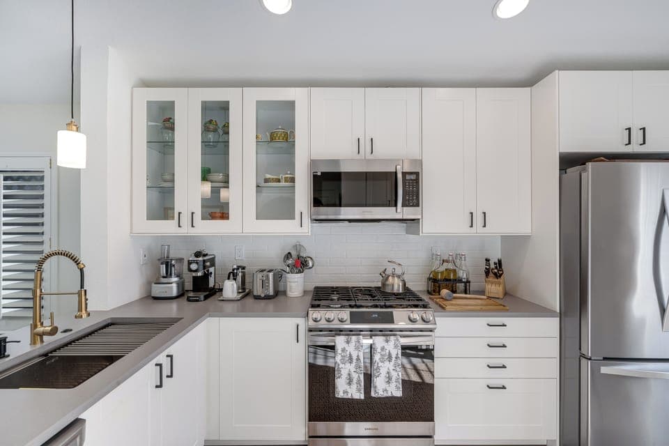 Your sleek kitchen features premium appliances, gleaming countertops, and thoughtful touches that make cooking a joy during your stay.