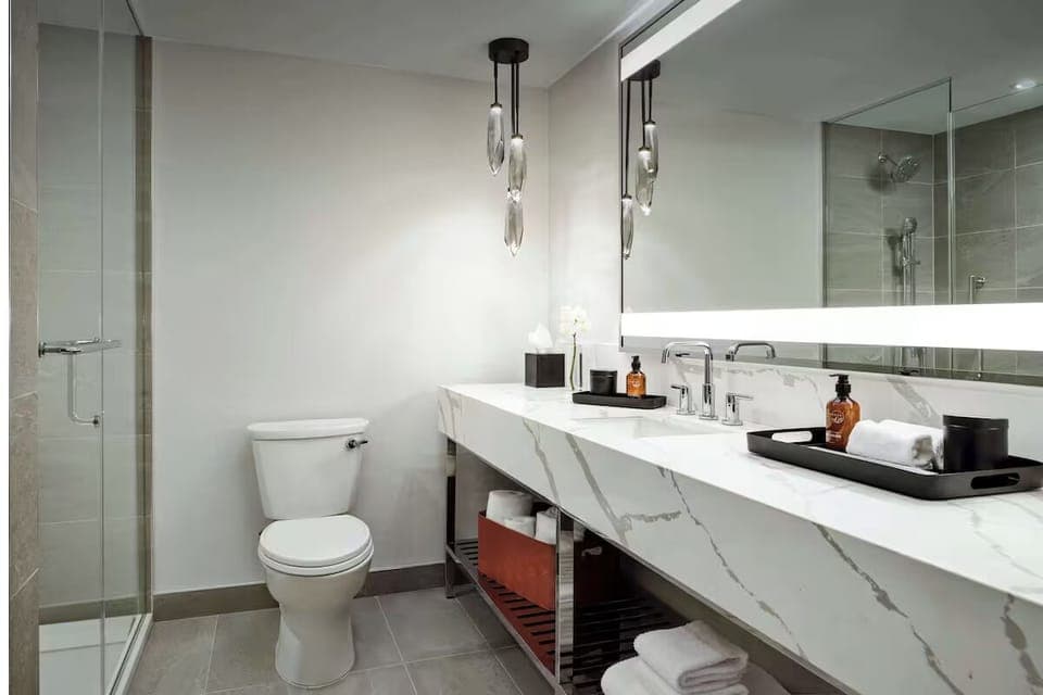 Refresh in a sleek bathroom with glass shower enclosure.