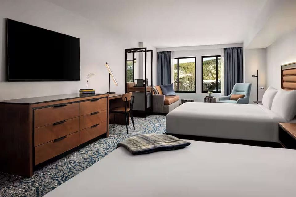 Unwind with lounge seating, big TV, and airy comfort.