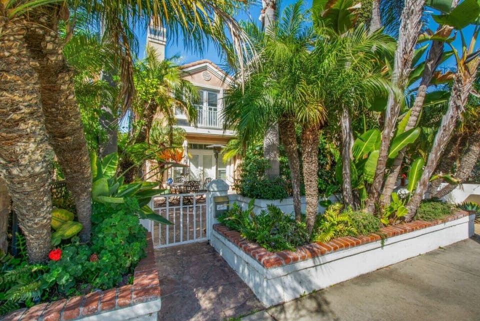 Private gated entrance surrounded by tropical landscaping, welcoming you into your Huntington Beach retreat.