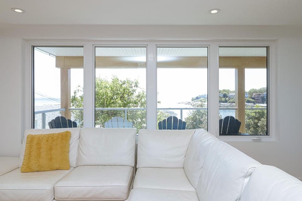 Perfect blend of simplicity and serenity, with wide windows showcasing the sea