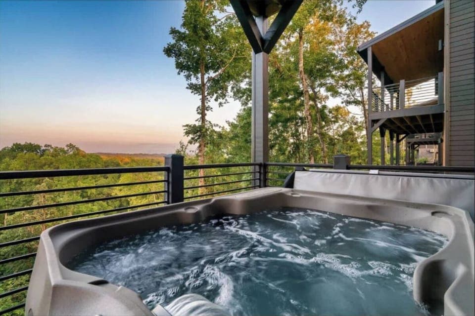 Soak in the bubbling hot tub while watching stunning sunsets paint the sky over treetops—pure relaxation awaits you here.