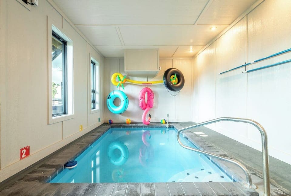 Your private indoor pool awaits, complete with colorful floats and crystal-clear water—perfect for splashing around any time of day, rain or shine.