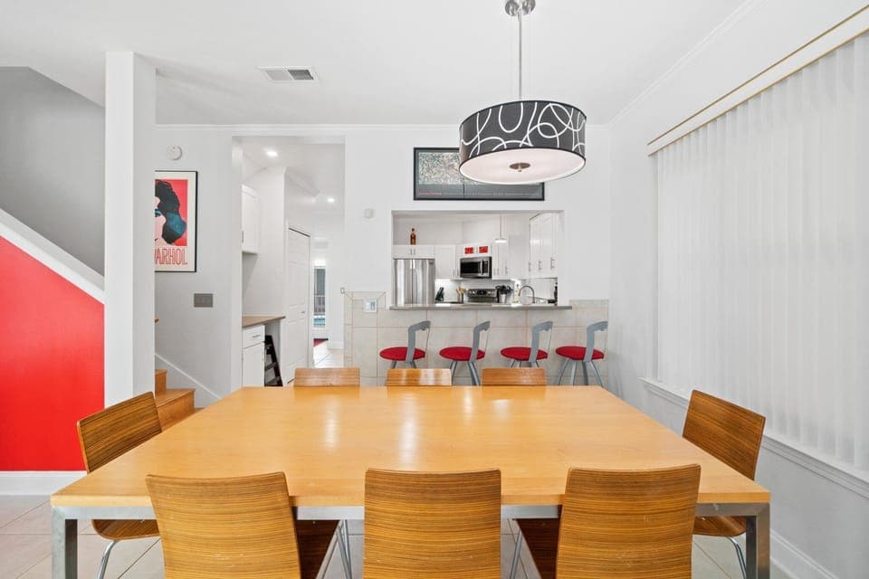 Large dining table with seating for the whole group, plus additional bar seating overlooking the kitchen.