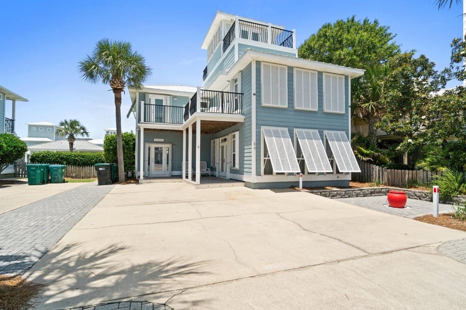 Spacious driveway with parking and charming coastal-style exterior.