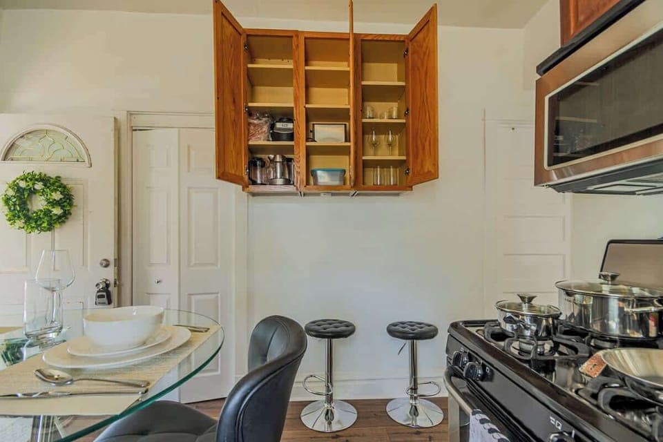 Kitchen detail w/ dining setup, wood cabinetry, & a welcoming everyday feel.


