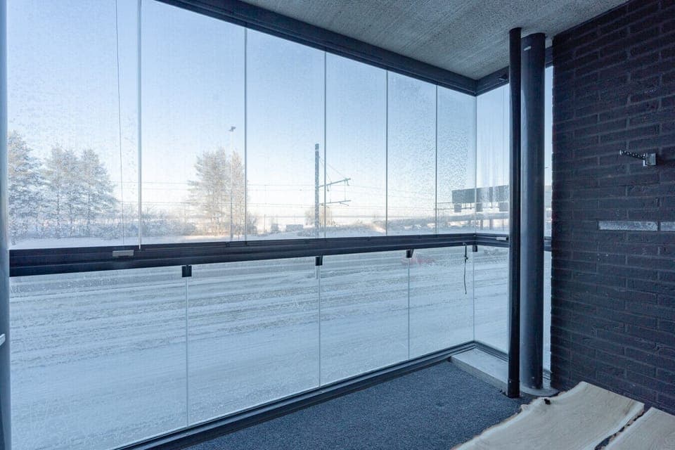 Spacious glass-enclosed balcony offering a bright, sheltered spot to enjoy the surrounding views.