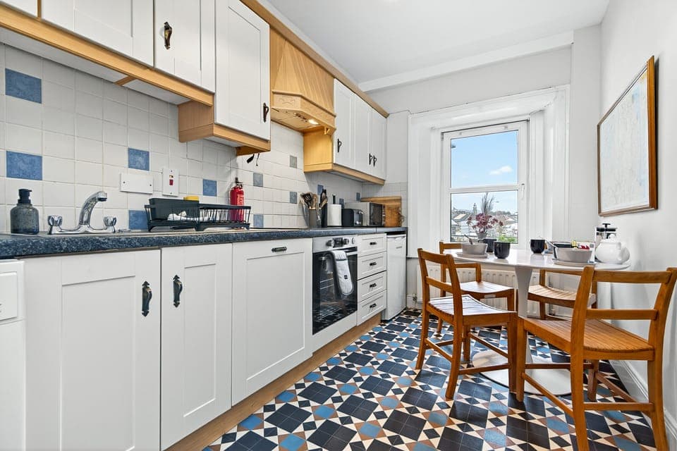 Bright and fully equipped kitchen with dining table