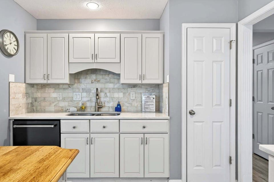 Kitchen: Modern kitchen setup featuring spacious counters, an elegant island counter, and all your cooking basics.