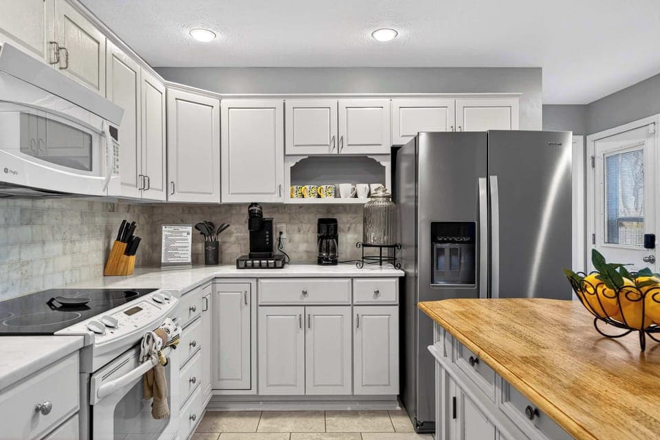 Kitchen: Modern kitchen setup featuring spacious counters, an elegant island counter, and all your cooking basics.