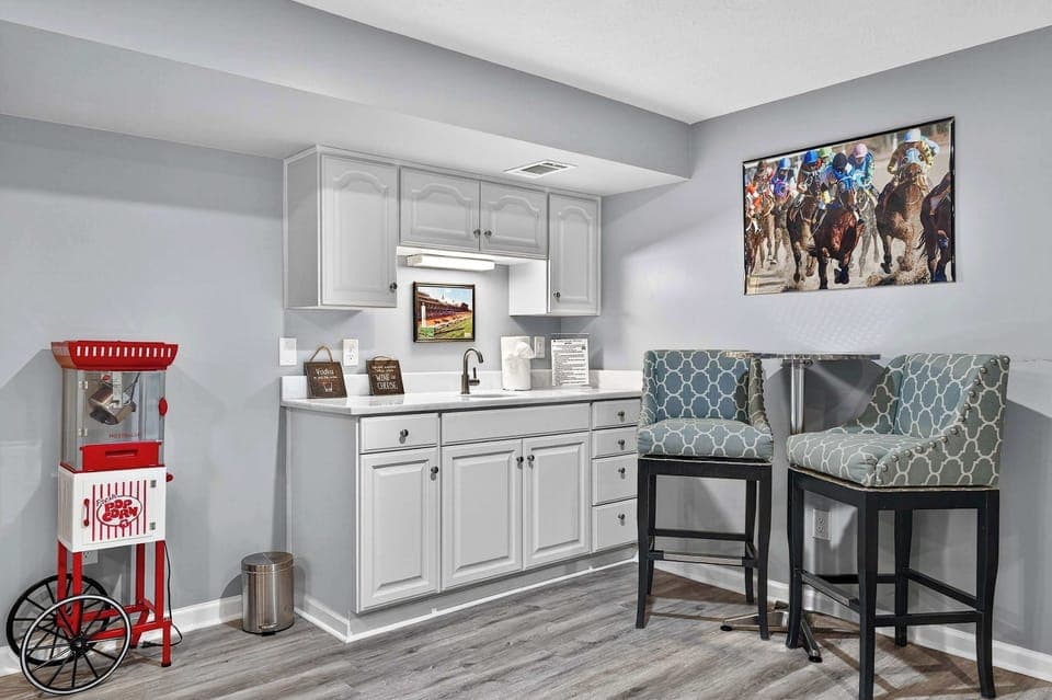 Kitchen: Modern kitchen setup featuring spacious counters, an elegant island counter, and all your cooking basics.