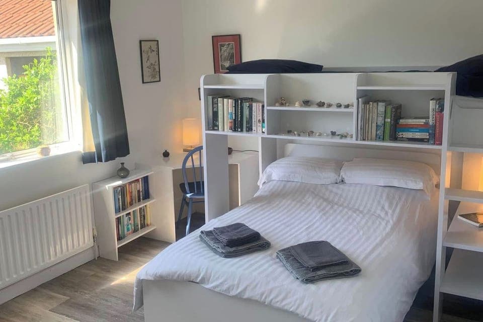 Bright 2nd bedroom with garden view. Fitted with very comfortable queen size bed with single overhead bed, perfect for couple or family. Bedroom includes built-in furiture and dressing table