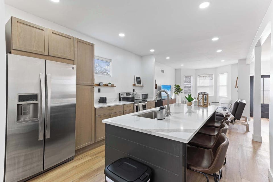 Modern kitchen with a large island, stainless steel appliances, and generous prep space. Ideal for cooking, casual dining, and gathering comfortably with family or friends.