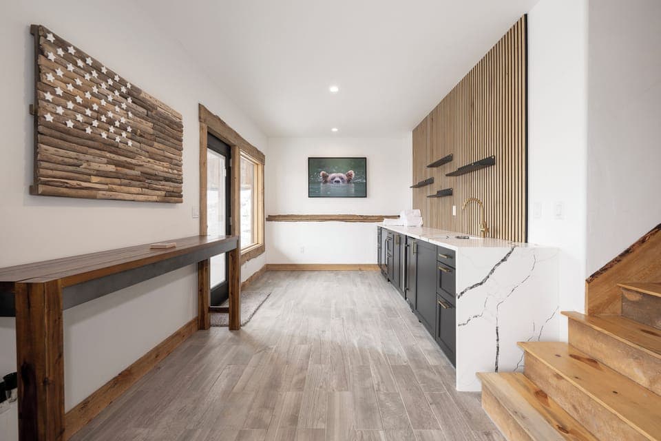 Your sleek wet bar area at 224 GCR 4034 blends modern luxury with mountain charm, featuring stunning marble countertops and warm wood accents.