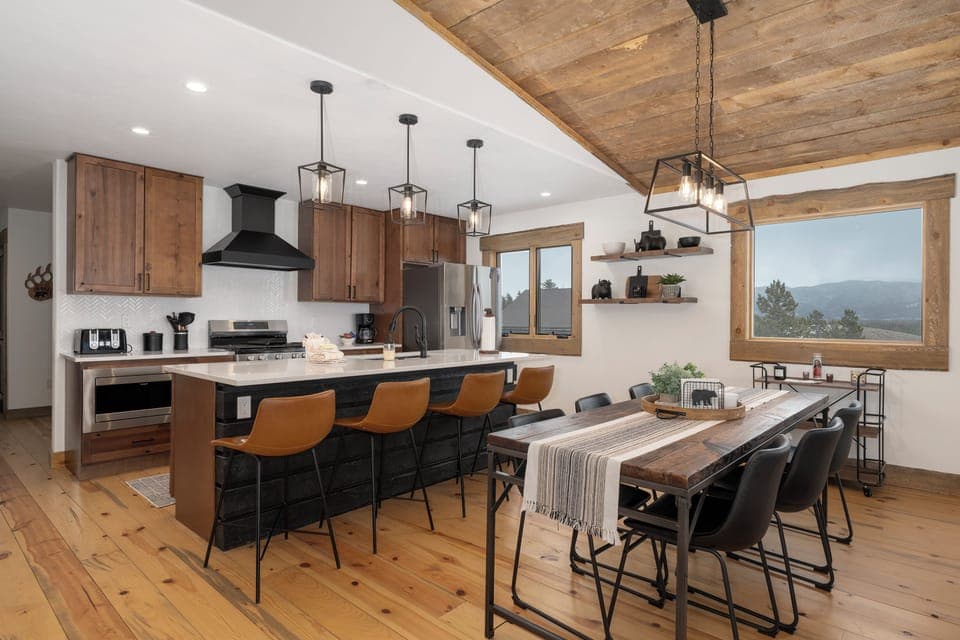 Your open kitchen at 224 GCR 4034 flows seamlessly into the dining area, where rustic beams meet modern comfort for memorable mountain meals.