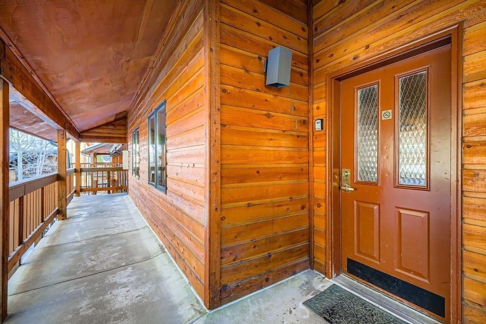 Step onto your private covered balcony where rustic wood charm meets mountain comfort, creating the perfect spot to unwind after adventure-filled days.