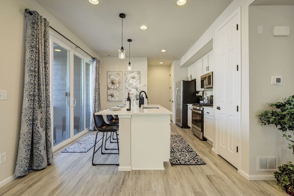 The kitchen is fully stocked and equipped with stainless steel appliances, quartz countertops.