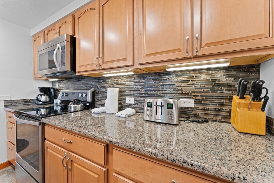 Full kitchen with stainless steel appliances.
