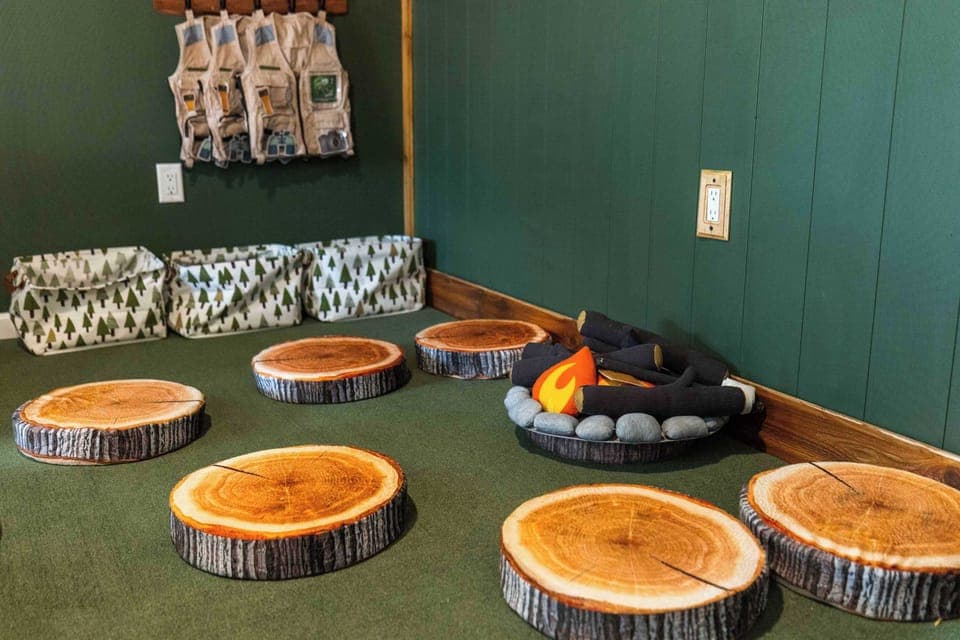 Embrace adventure on playful tree stumps around a whimsical campfire scene!