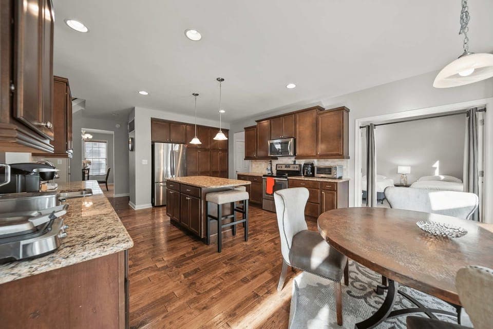 Bright kitchen w/ island seating, wood floors & plenty of prep space