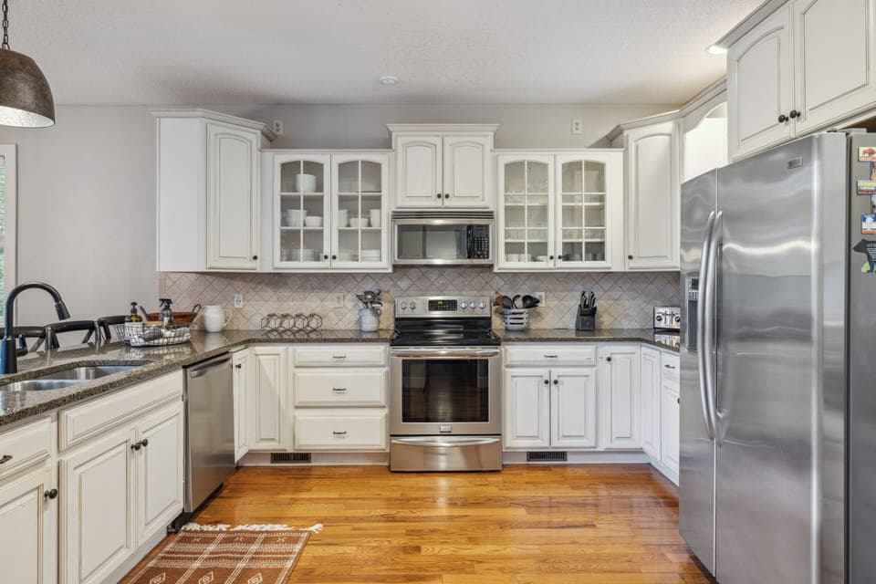 Fully equipped kitchen with stainless steel appliances and ample counter space.