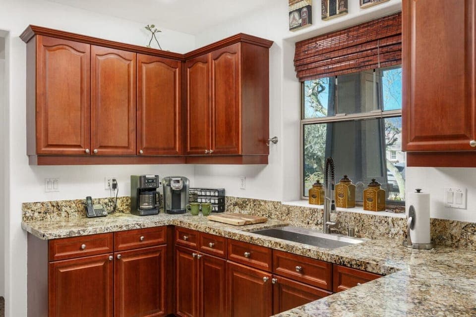 Ample storage and a peninsula countertop with barstools for casual dining.