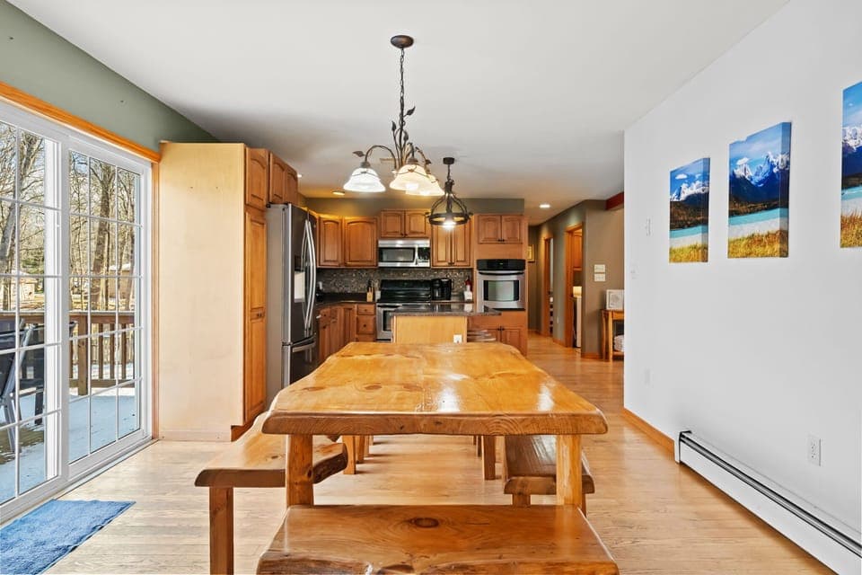 Dining nook with log accents, landscape art, and a handcrafted bench