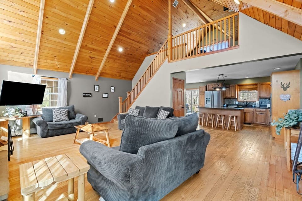 Step inside to vaulted wood ceilings, a stone fireplace, and cozy seating for everyone