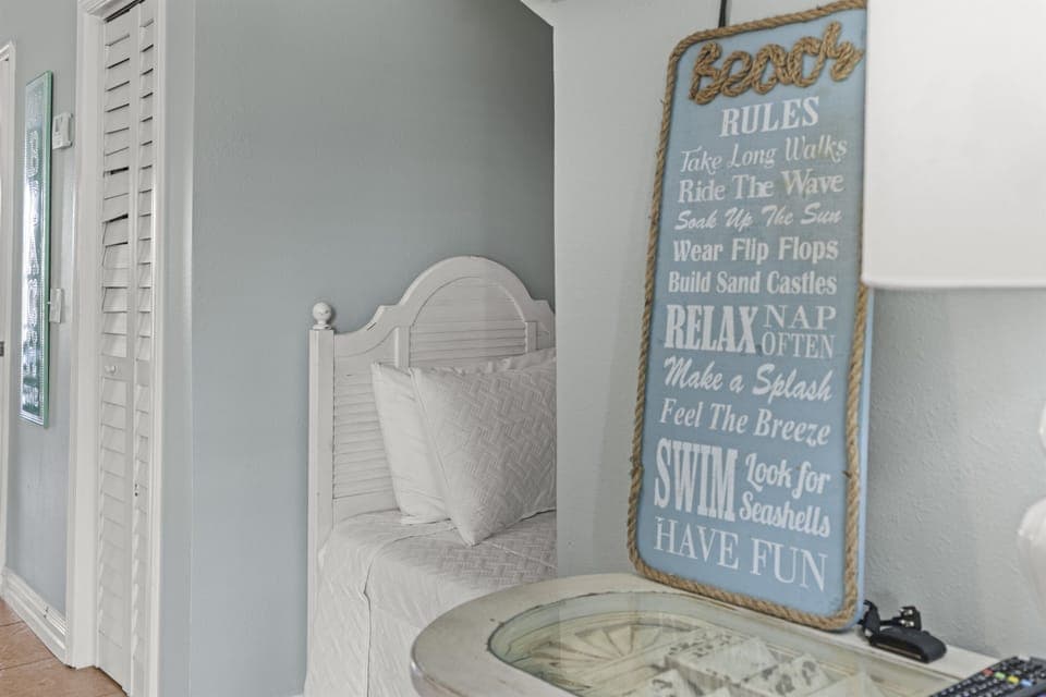 Drift off in your coastal-themed bedroom where soft linens meet charming beach decor, creating the perfect seaside sanctuary.