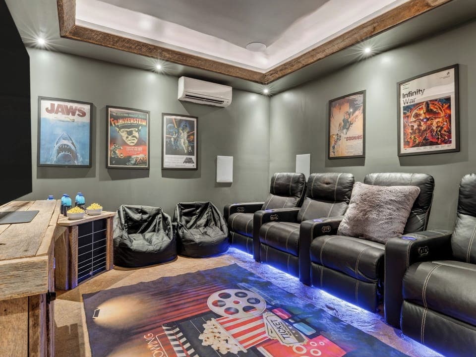 Private theater room with recliner seating for movie nights and group hangouts. (Aspen Lodge)