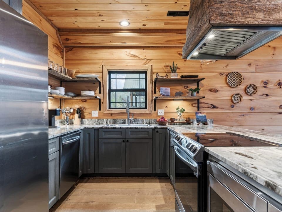 Well-equipped kitchen with a large island, bar seating, and plenty of room to cook together. (Aspen Lodge)