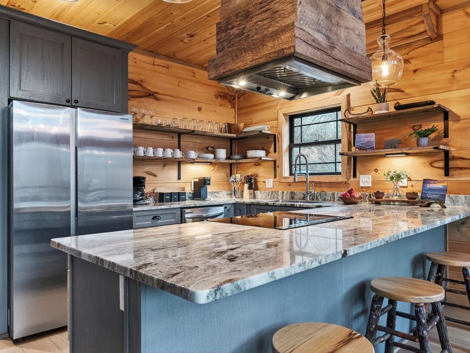 Well-equipped kitchen with a large island, bar seating, and plenty of room to cook together. (Aspen Lodge)