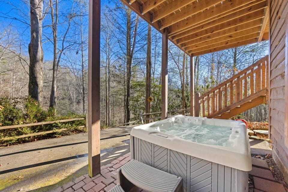 Relax in the bubbling hot tub as you enjoy the peaceful ambiance of the surrounding trees.