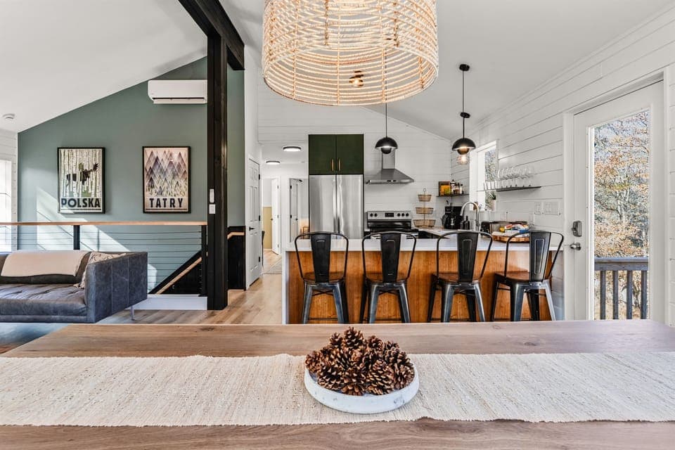 Enjoy the bright, open-concept main floor, where the cozy seating area, fully equipped modern kitchen with island seating, and dining space flow effortlessly for relaxed group living.