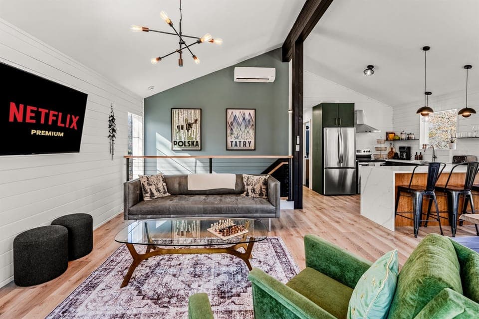 Experience our beautiful open-concept upper level, where the stylish living room flows effortlessly into a fully equipped modern kitchen—ideal for entertaining and creating unforgettable momen