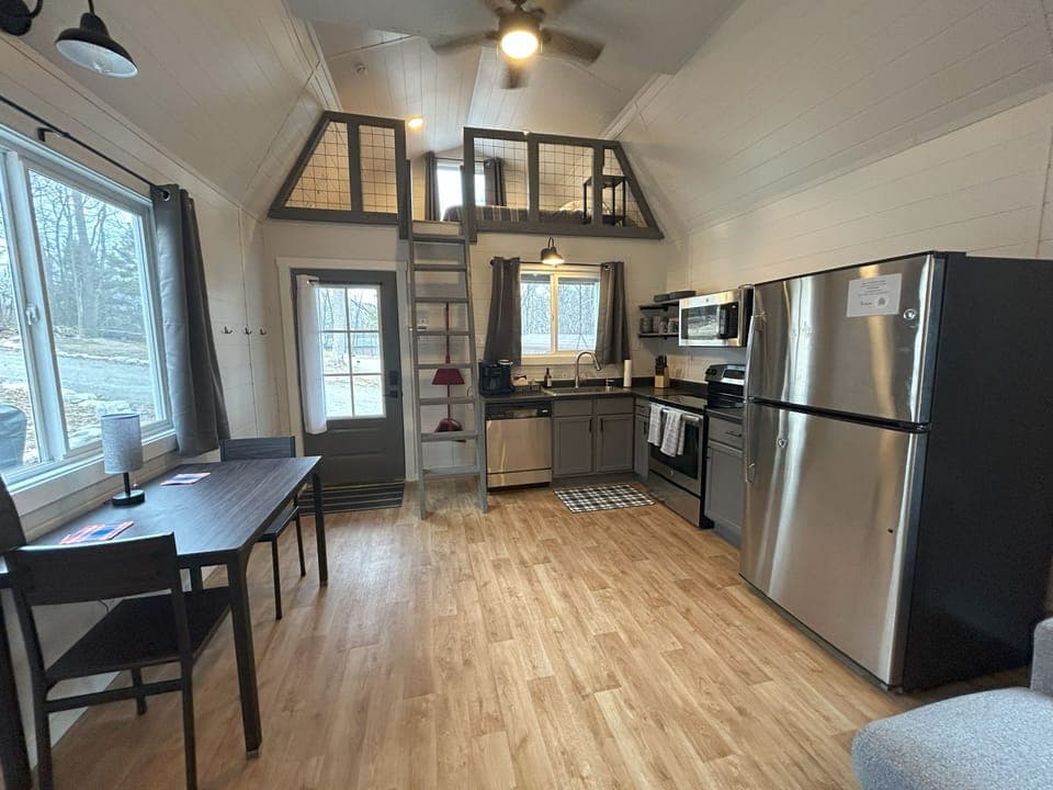 Kitchen and dining area in open-concept space; front loft with queen bed