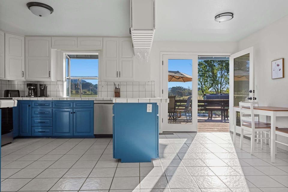 Seamless indoor-outdoor flow—step straight from the newly renovated kitchen to the deck for a sunset meal under the umbrella.