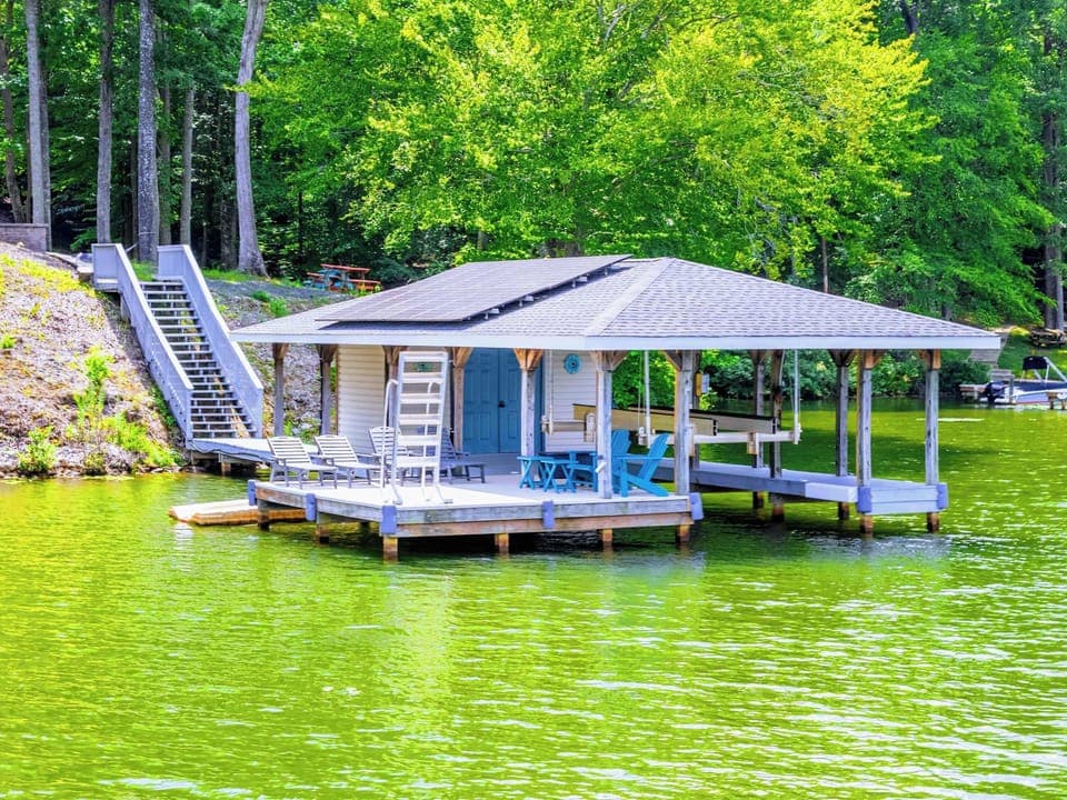 Your morning starts here: coffee in hand, bare feet on the dock, the lake still and golden before the boats come out.