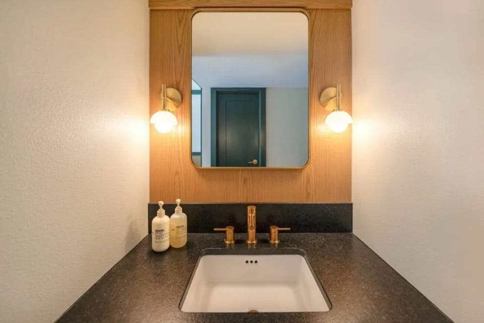 Prepare for the evening at a polished vanity with warm light.