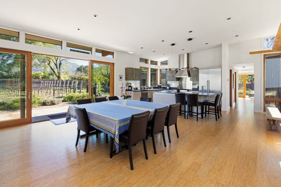 Gather around this stunning open-plan kitchen and dining space, where floor-to-ceiling windows frame vineyard views while you cook and dine.
