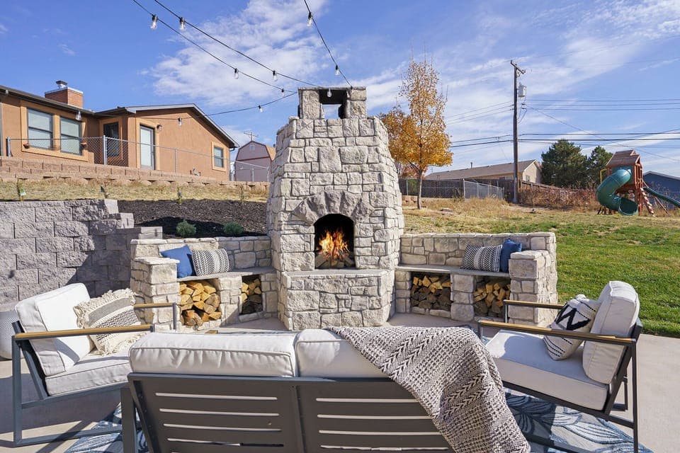 Rustic outdoor fireplace with ambient seating for cooler nights.