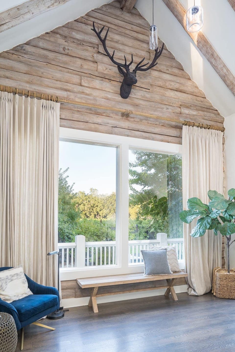 Soaring windows and rustic wood accents create a light-filled space - perfect for quiet moments with peaceful garden views.