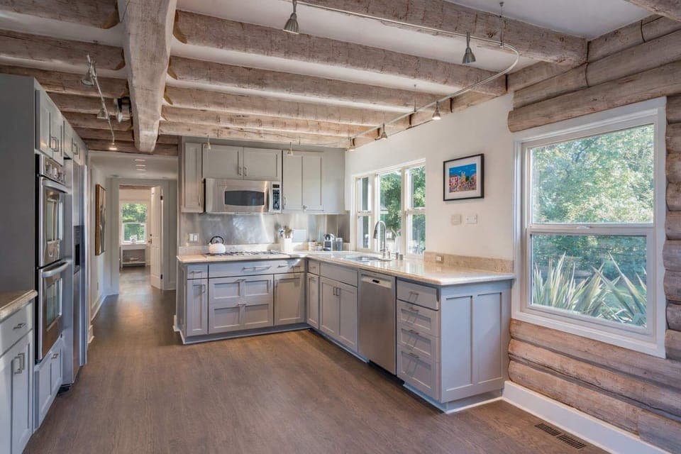 Warm, light-filled kitchen with open beams and modern finishes - designed for slow mornings, shared meals, and effortless gathering.