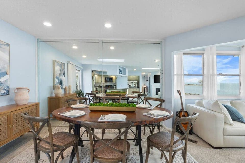 Gather around the dining table with open-concept views and Lake Erie just beyond the windows.