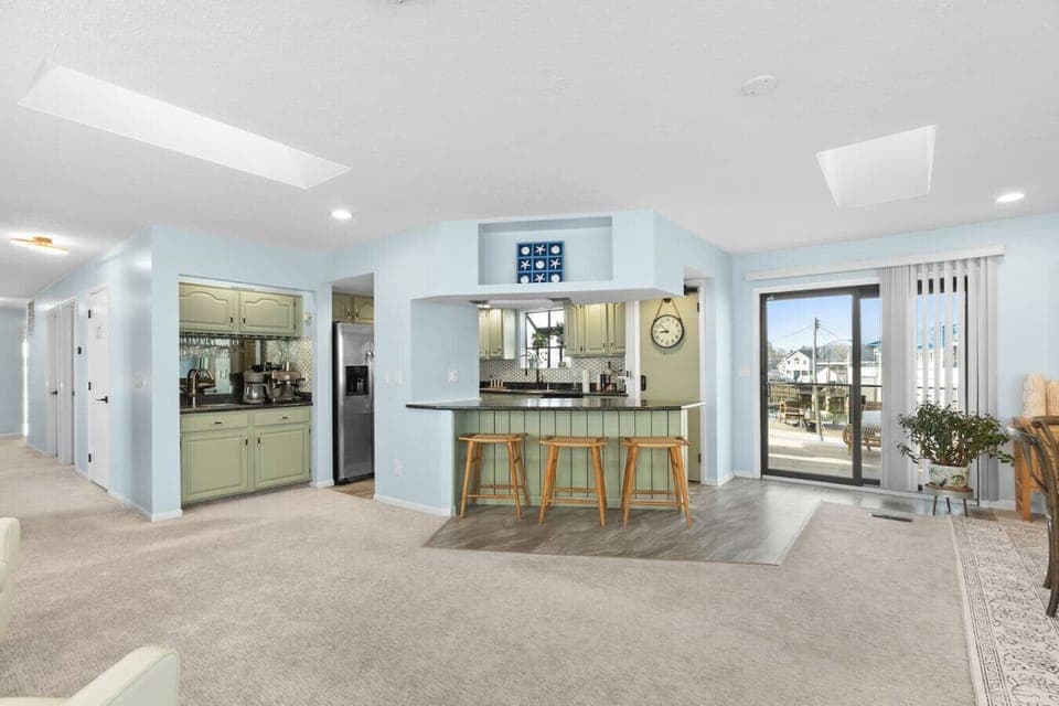 Open-concept kitchen and bar area viewed from the living room—perfect for gathering and entertaining.