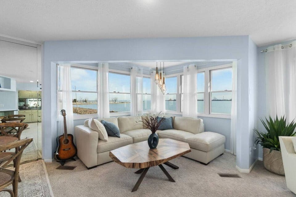 Relax in the sunlit lounge with panoramic water views and Cedar Point visible in the background