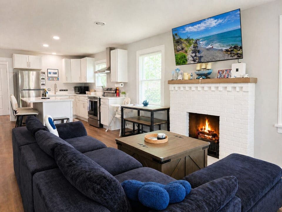 Inviting family room featuring plush seating, warm fireplace, ambiance